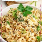 White bowl filled with everything bagel deviled egg pasta salad.