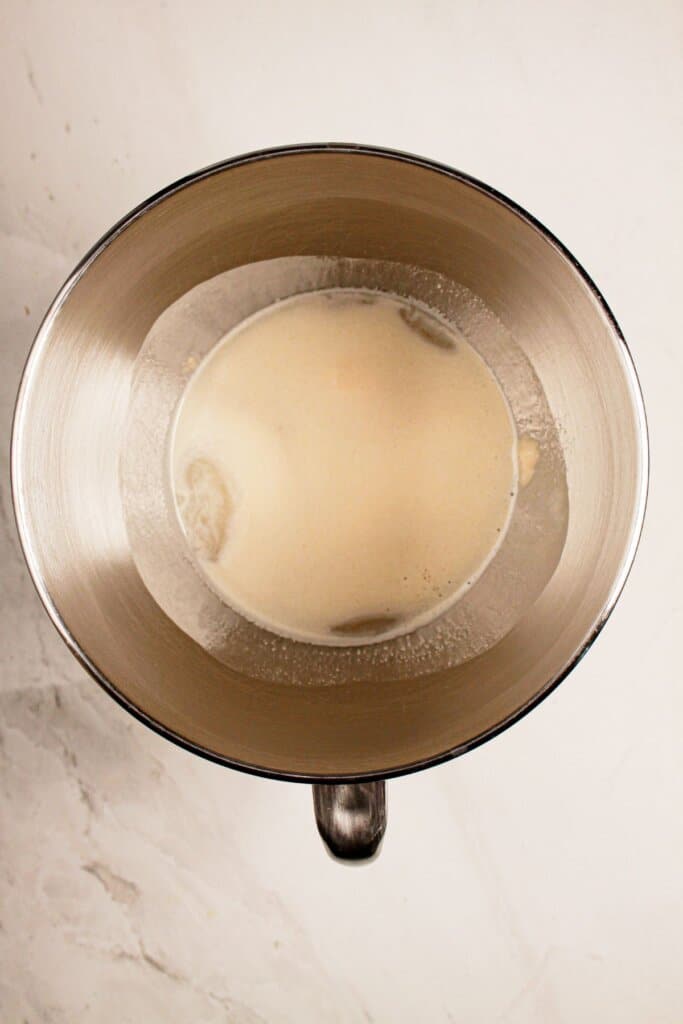 Yeast, honey, and water in a mixing bowl.