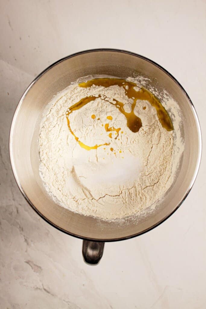 Flour and oil being added to a mixing bowl.