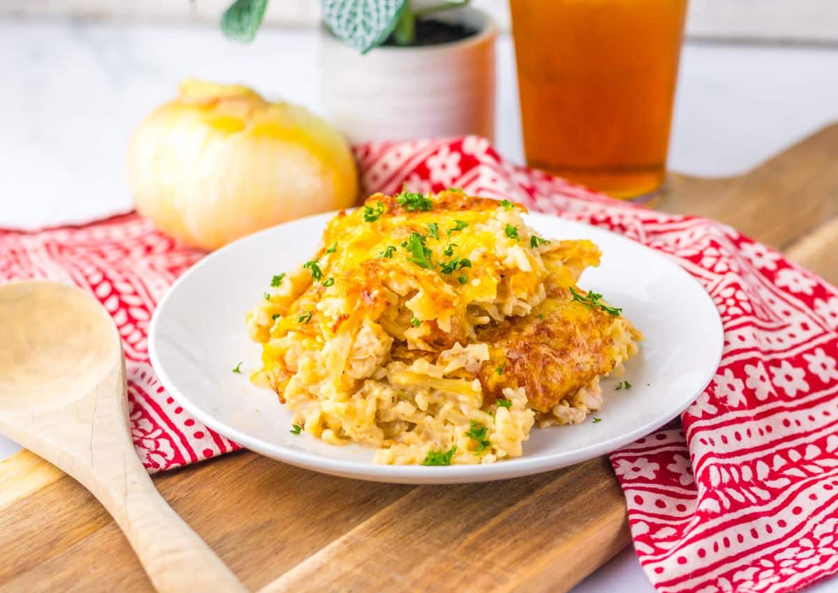 Serving of french onion chicken and rice on a plate.
