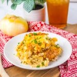 Serving of french onion chicken and rice on a plate.