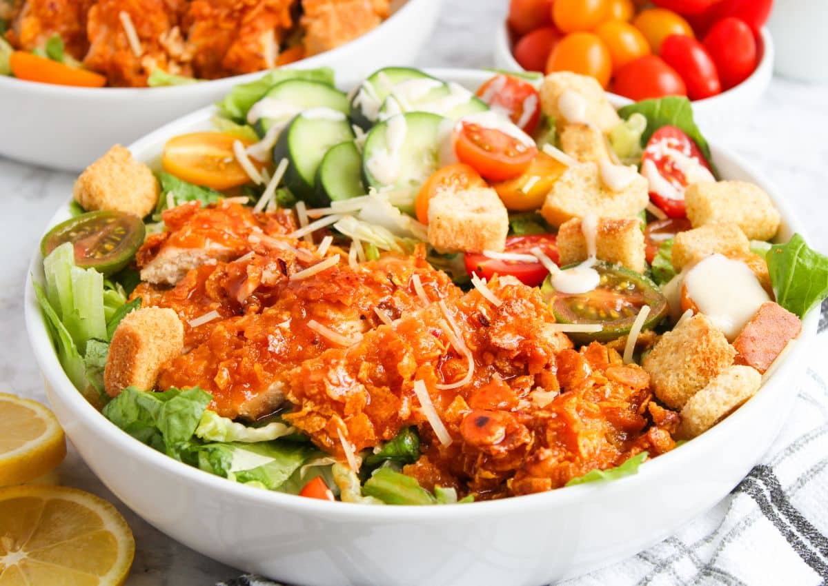 White bowl full of hot honey chicken salad.