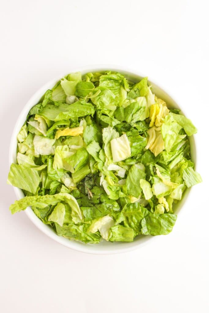 White bowl filled with lettuce.
