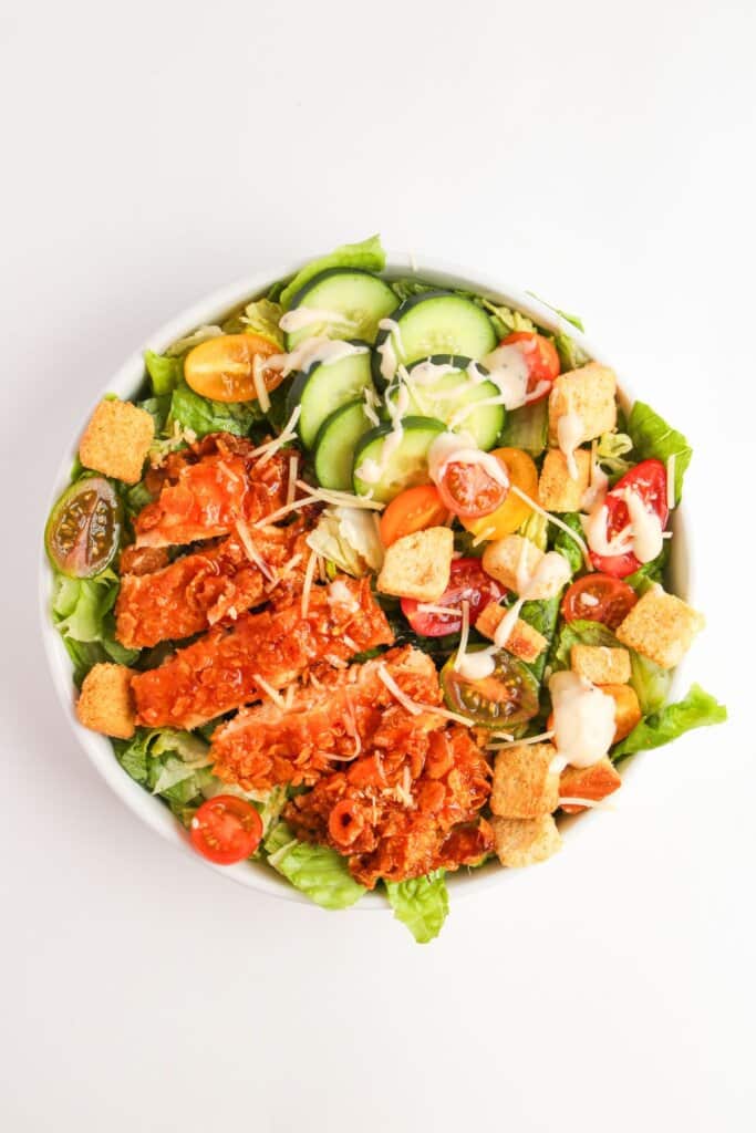 White bowl filled with hot honey chicken salad.