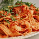 Large serving platter full of Italian drunken noodles.