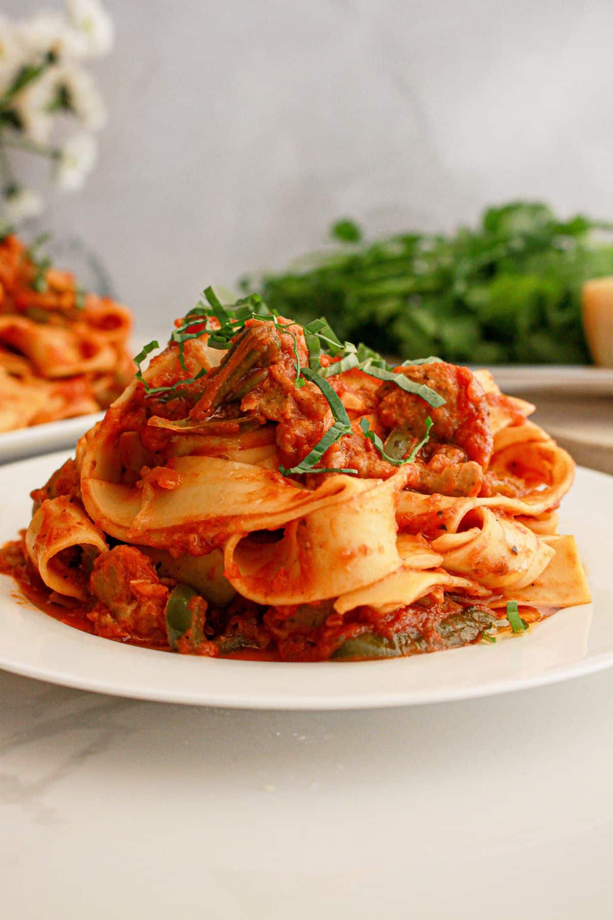 Large serving platter full of Italian drunken noodles.