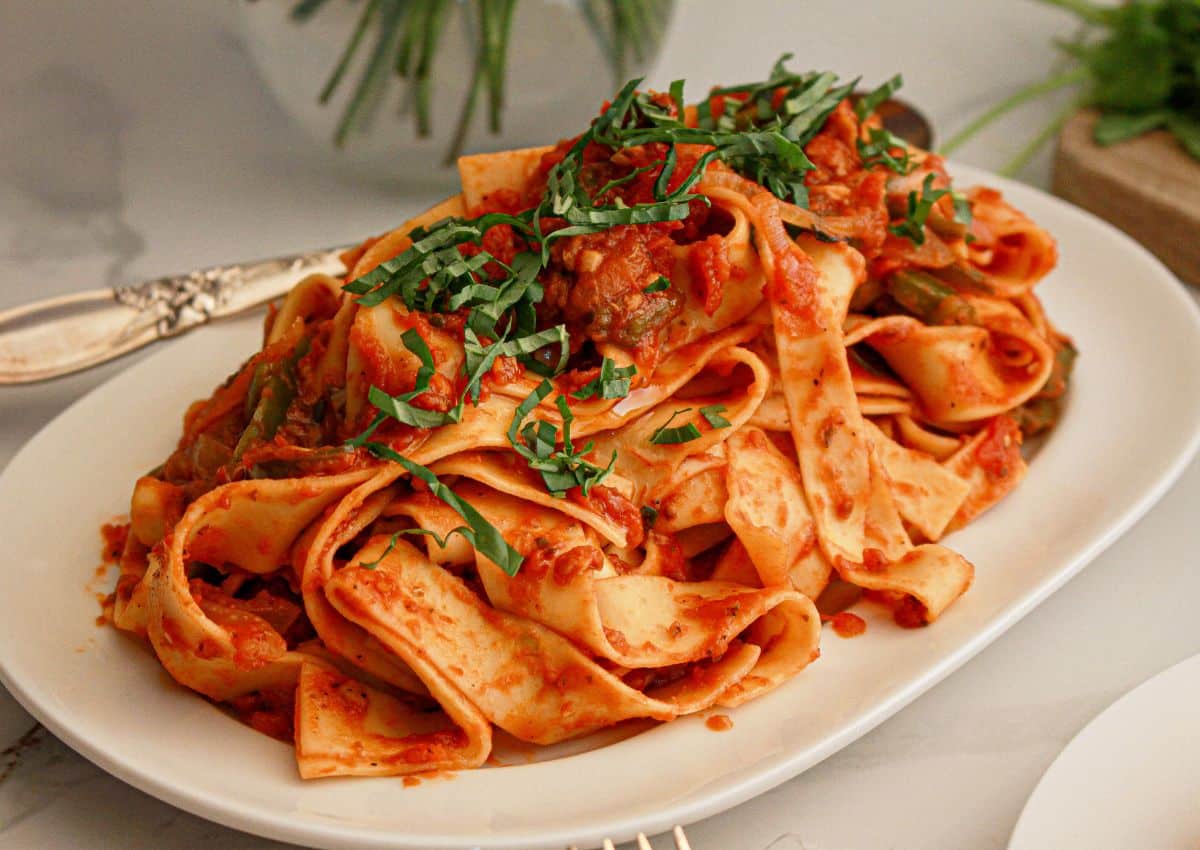Large serving platter full of Italian drunken noodles.