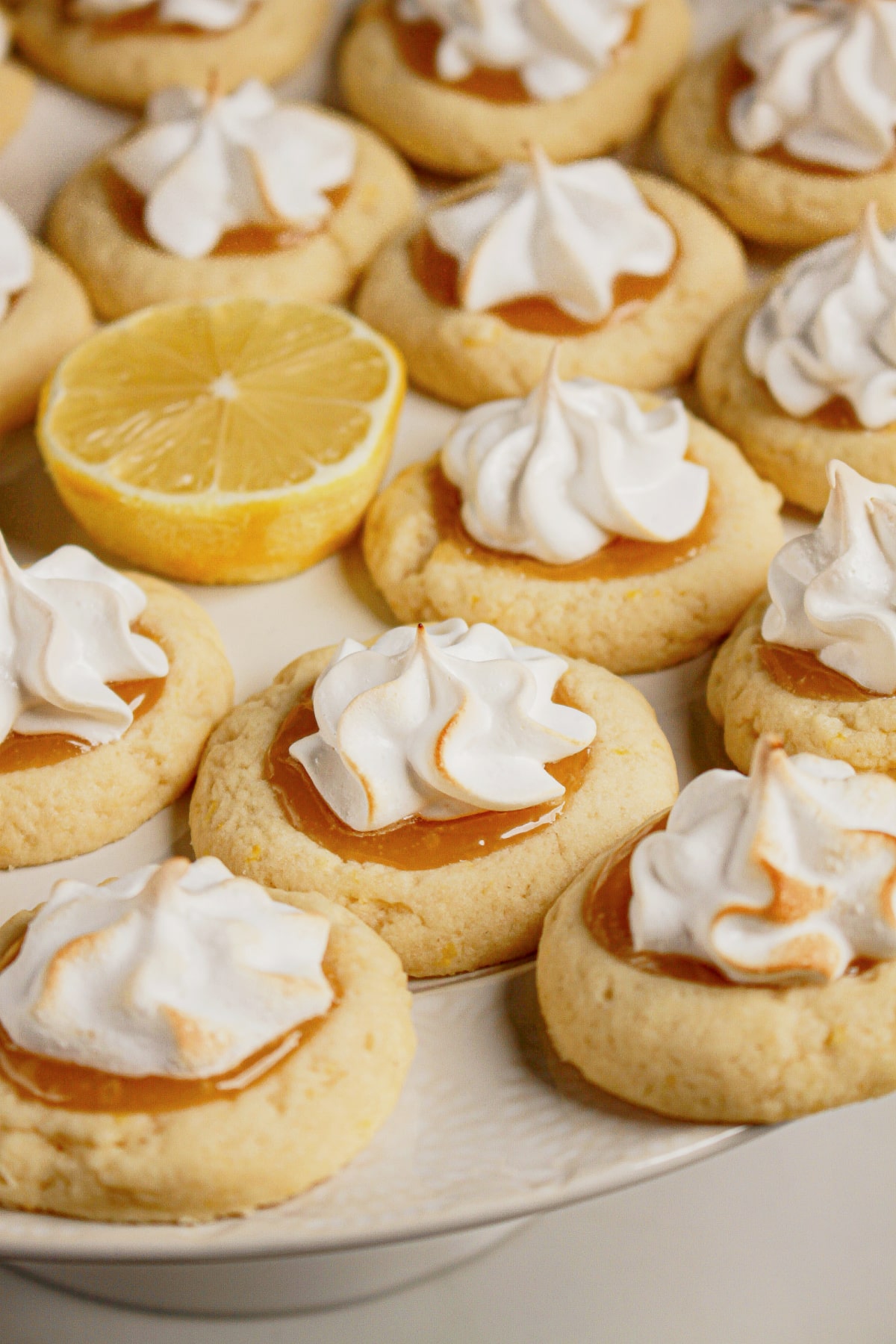 Lemon meringue cookies on a white plate.