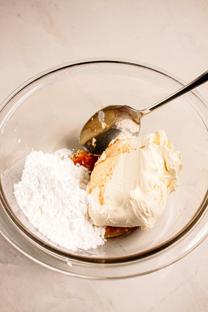 Cheesecake filling ingredients being mixed in a small bowl.