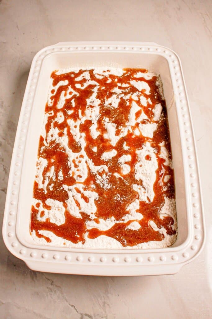 Melted butter drizzled on top of dessert in a baking dish.