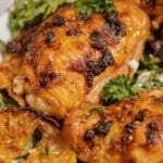 Sheet pan lemon chicken and arugula on a plate.