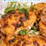 Sheet pan lemon chicken and arugula on a plate.