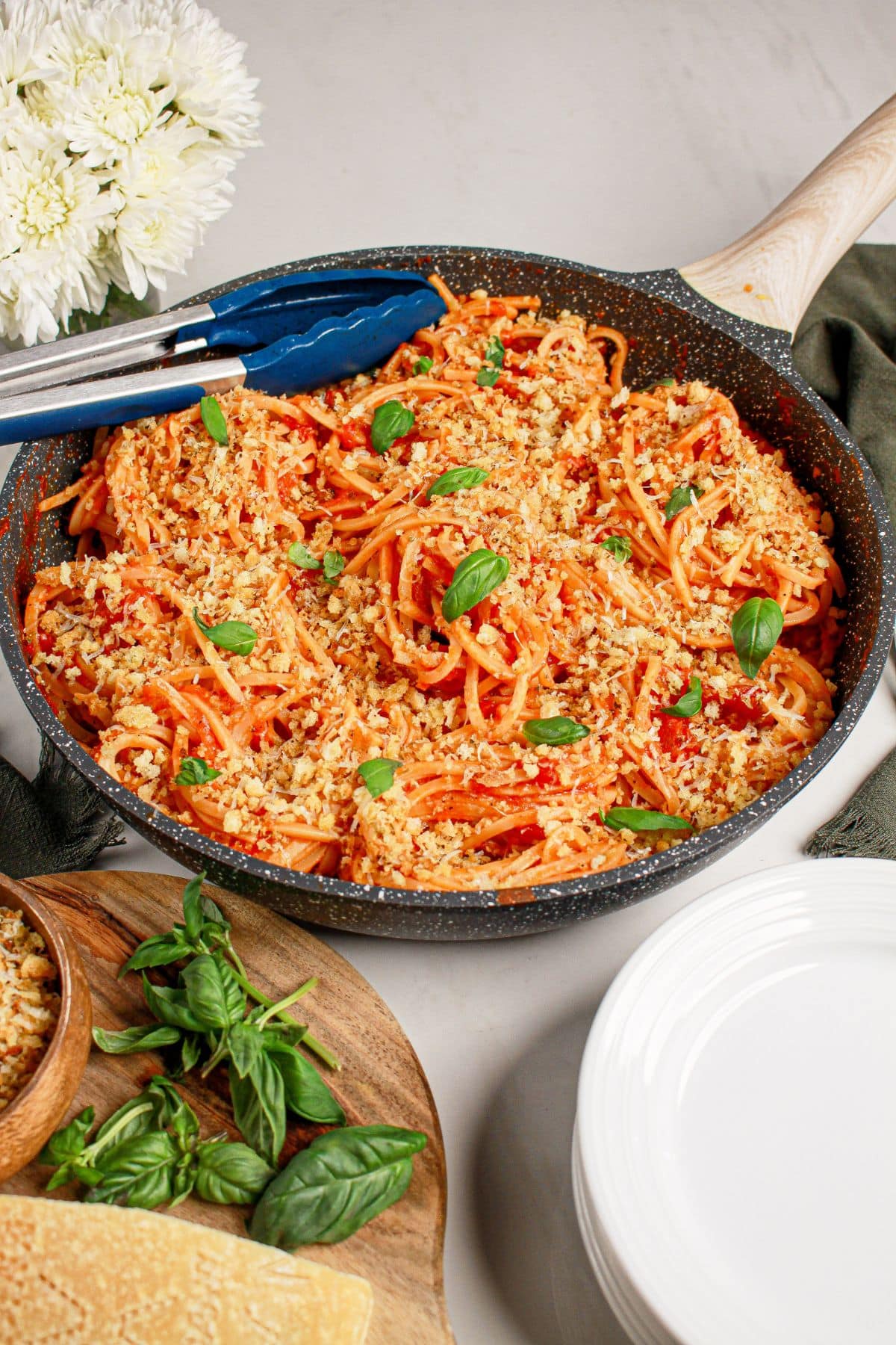 Cast iron skillet full of tomato butter pasta.