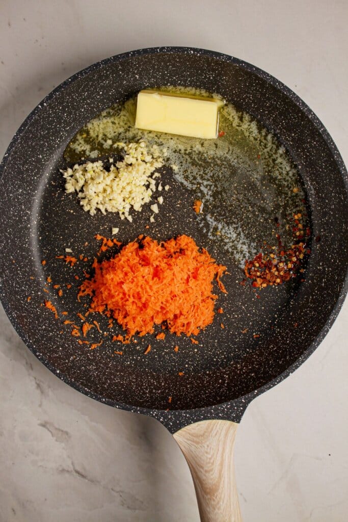 Garlic, carrots, and butter in a skillet.