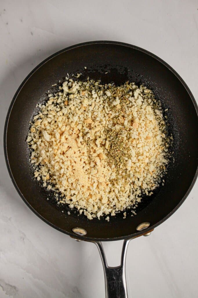Bread crumbs being toasted in a skillet.