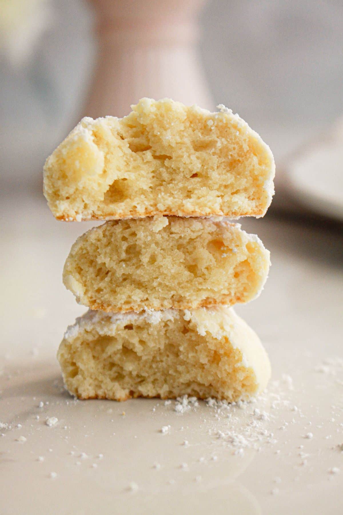 Half almond cream cheese cookies on a counter.
