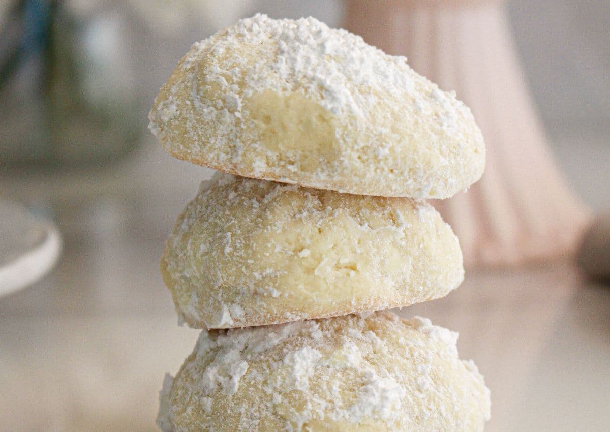 Three cream cheese cookies stacked on top of each other.