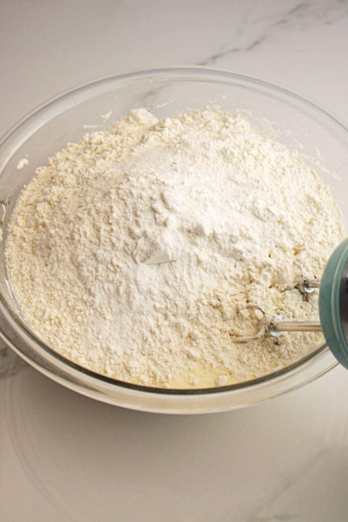 Dry ingredients being added to wet ingredients.