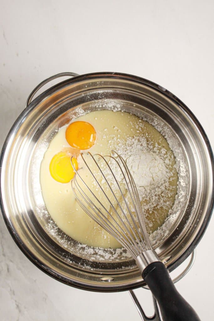 Homemade custard being made in a double boiler.