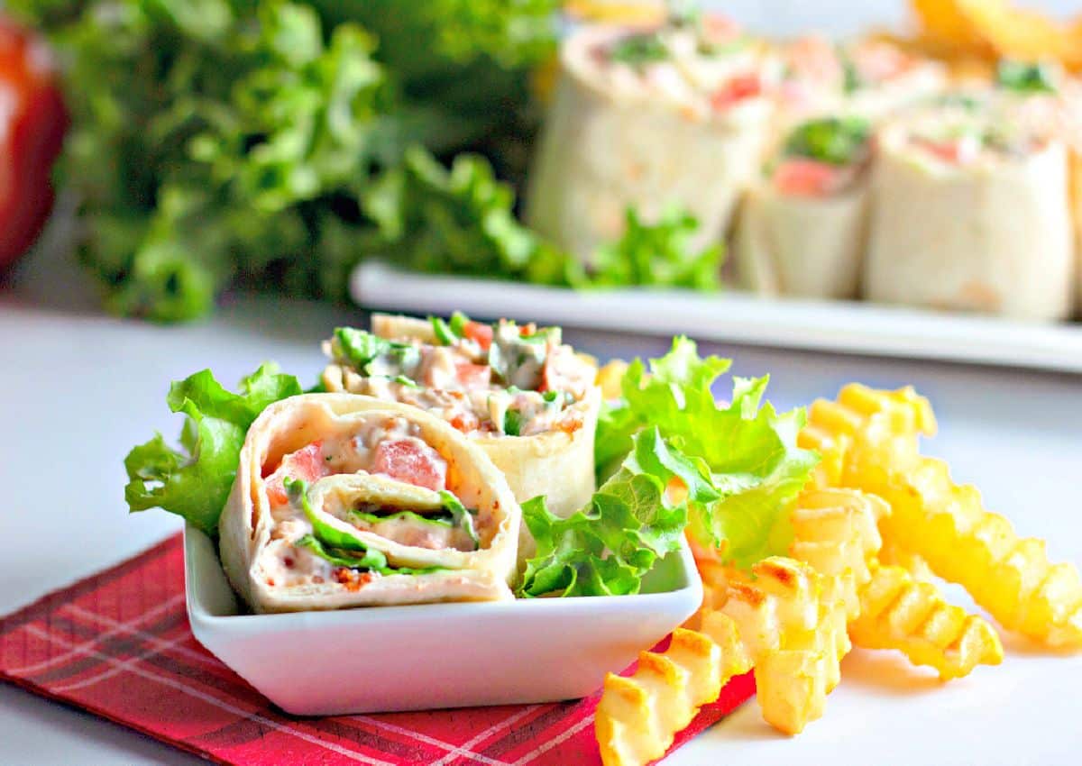 BLT roll ups on a plate.