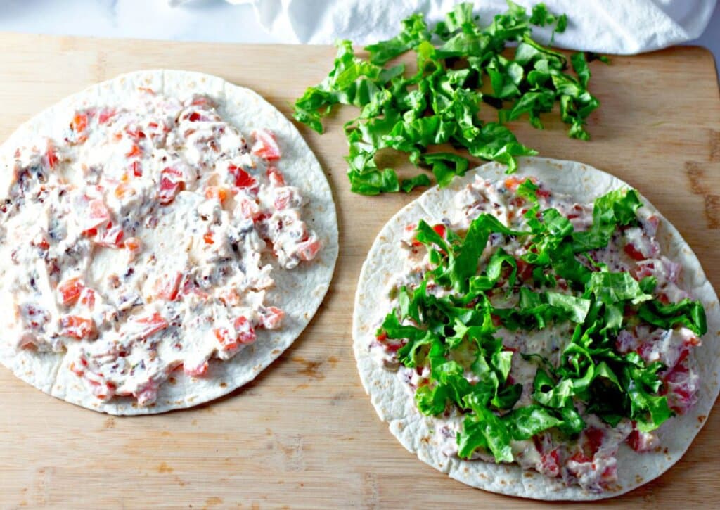 Tomato mixture being spread on tortillas.