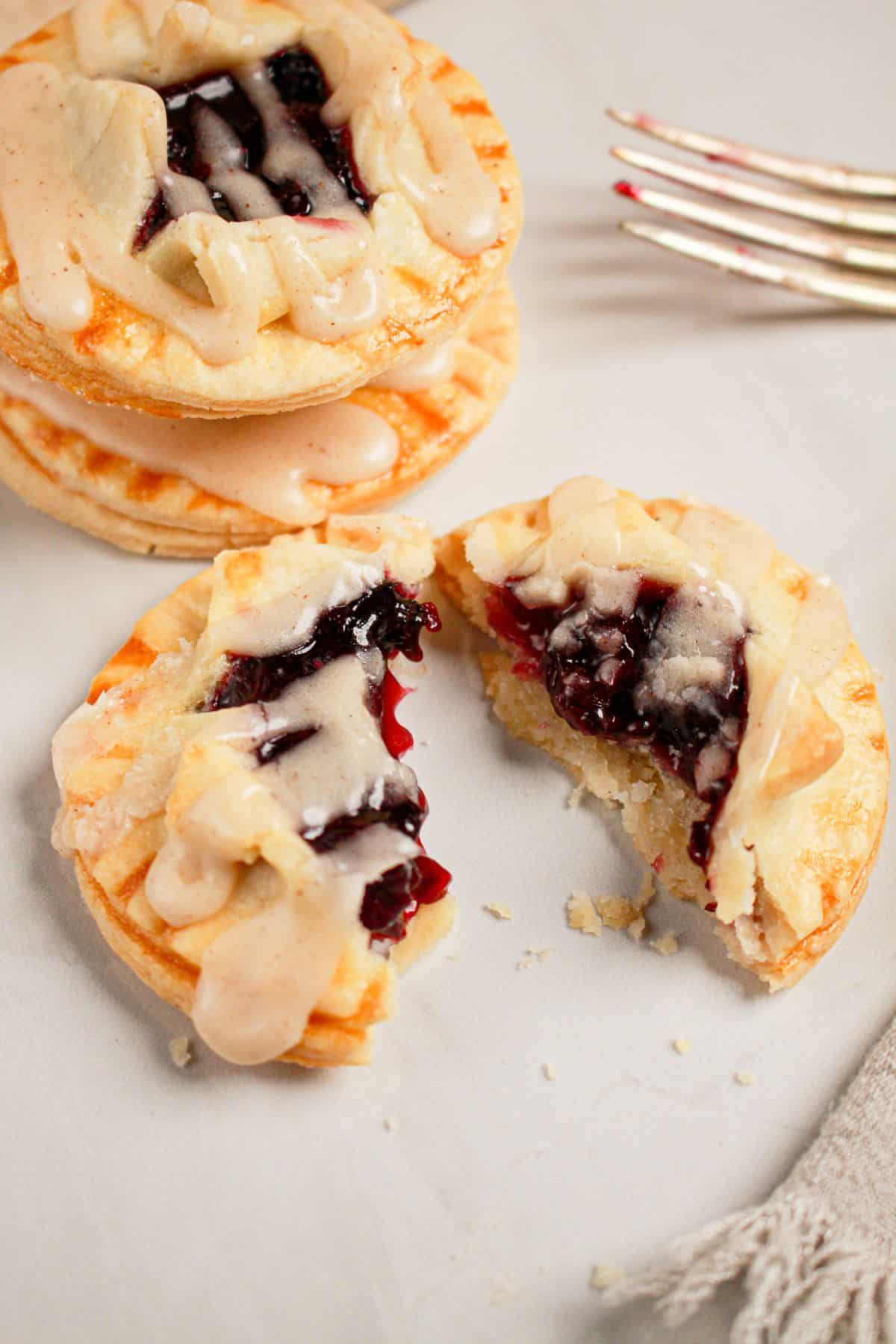 Blueberry pie cookie spilt half on a plate.