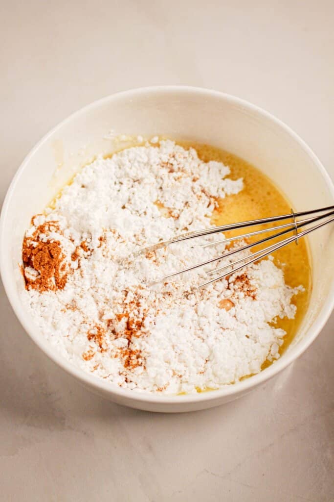 Glaze being mixed with a whisk in a small bowl.