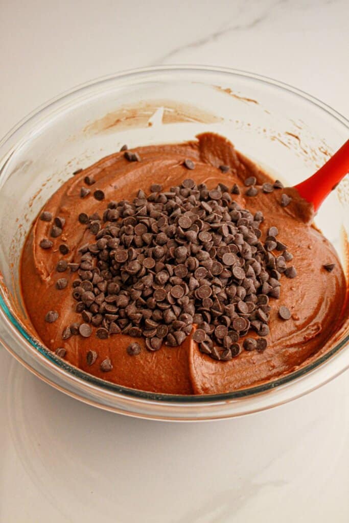 Chocolate chips being stirred into batter.