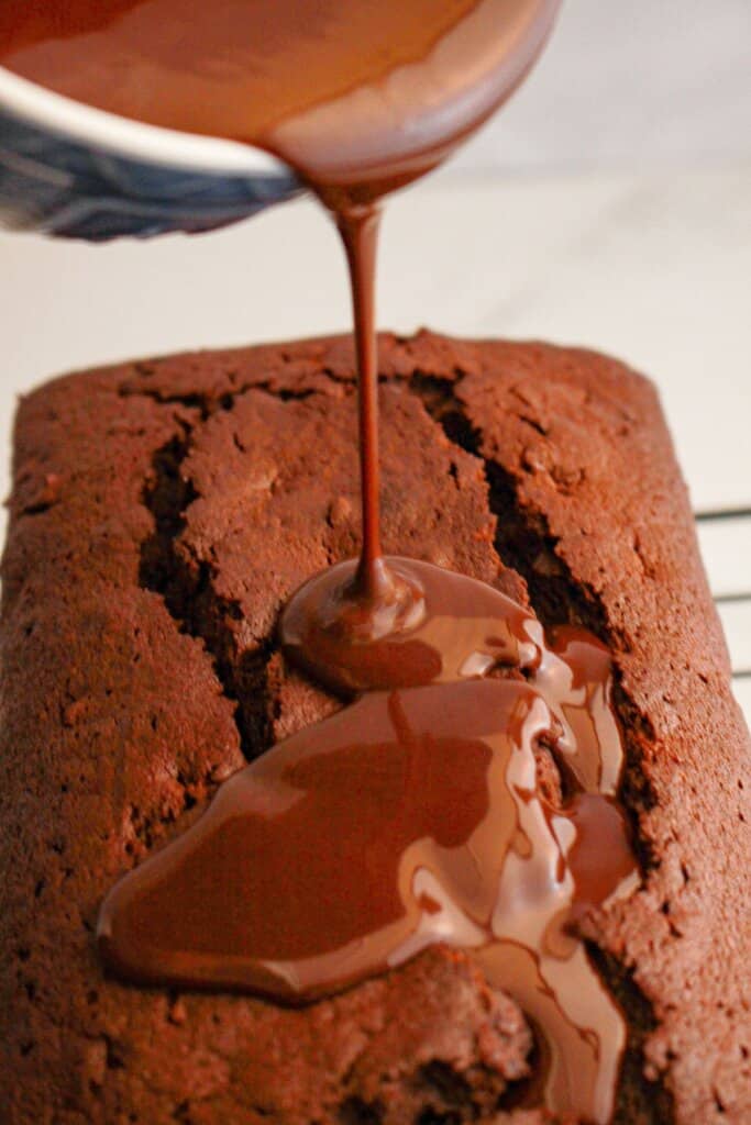 Glaze being poured on top of a dessert.