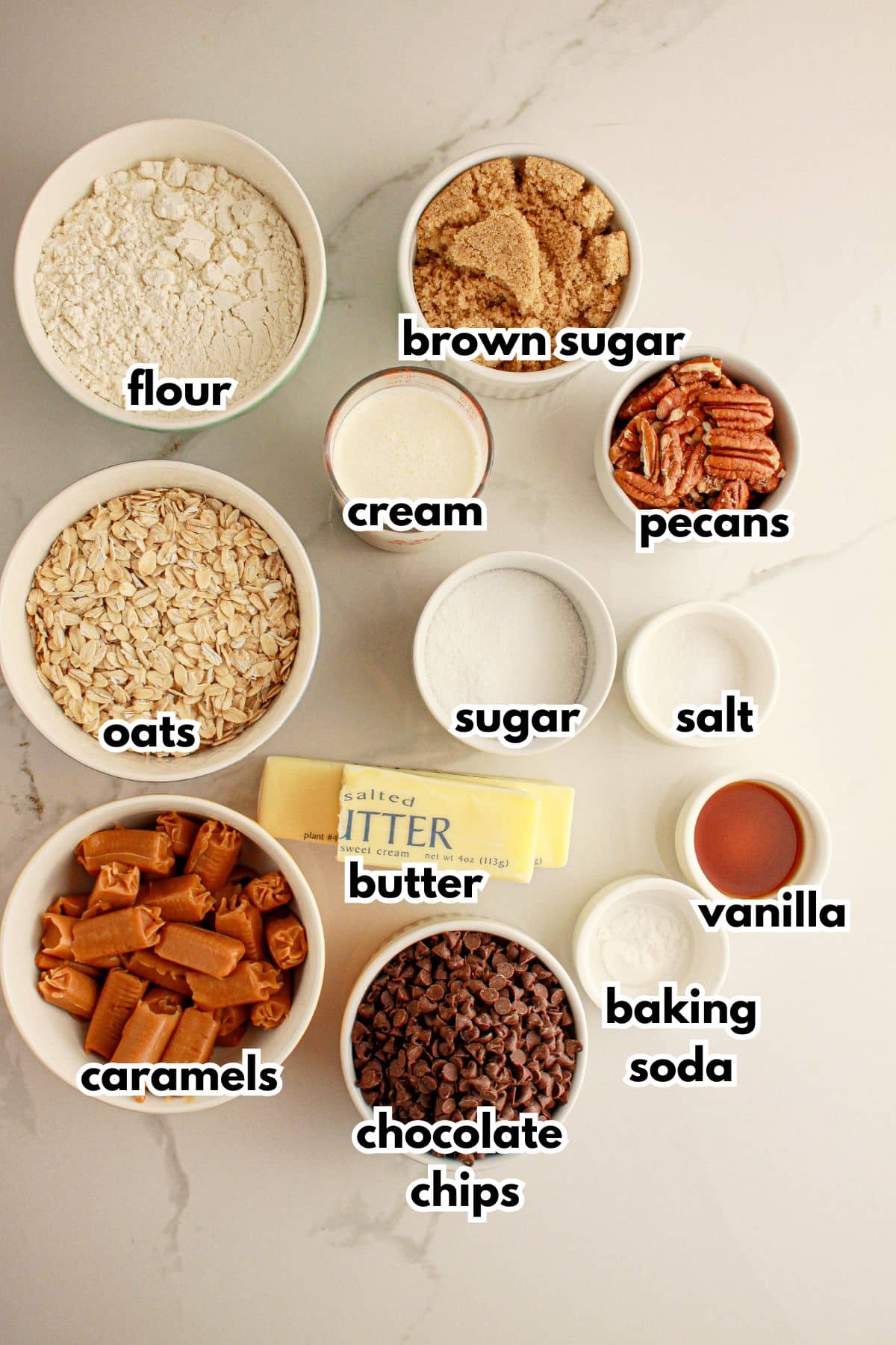 Bowls of ingredients labelled with text on a counter.