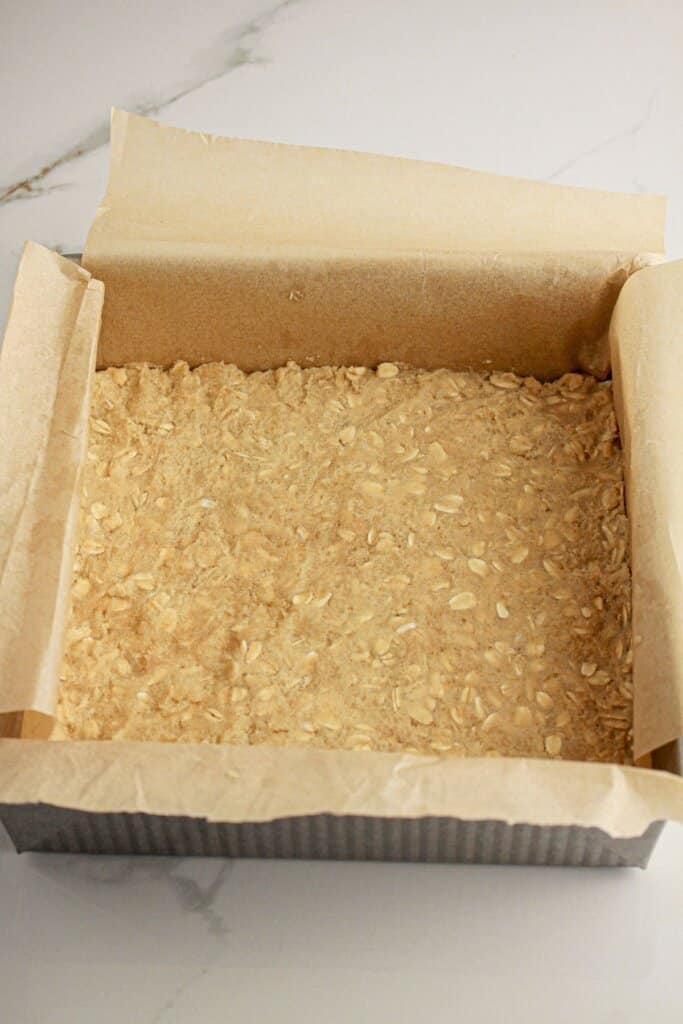 Crust being pressed into a baking dish.