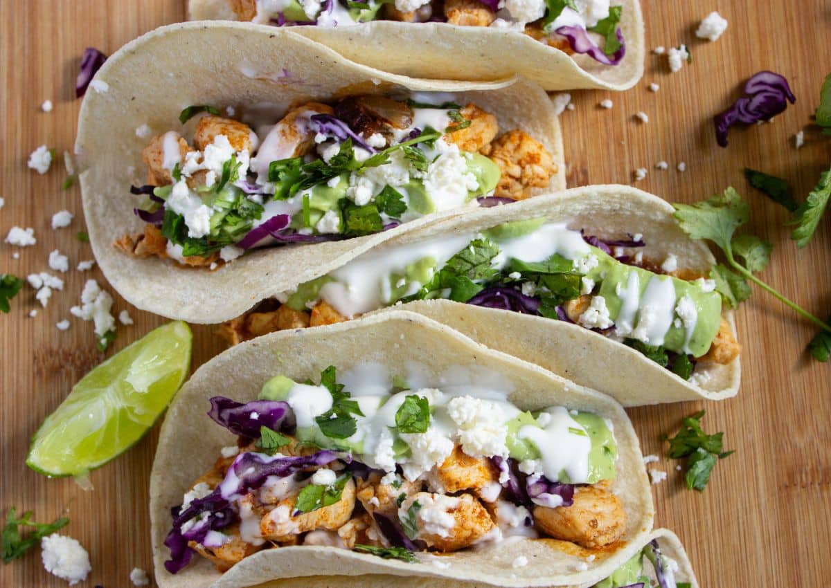Chipotle chicken tacos on a serving board.