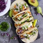 Chipotle chicken tacos on a serving board.