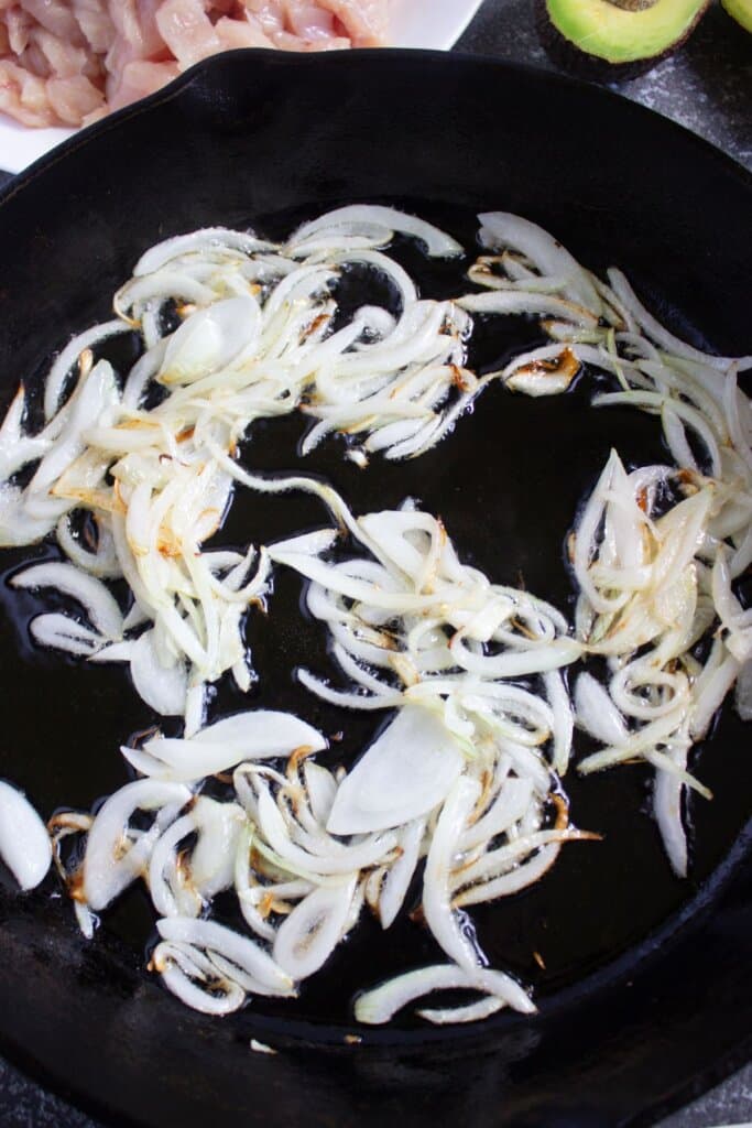 Onions being cooked in a skillet.