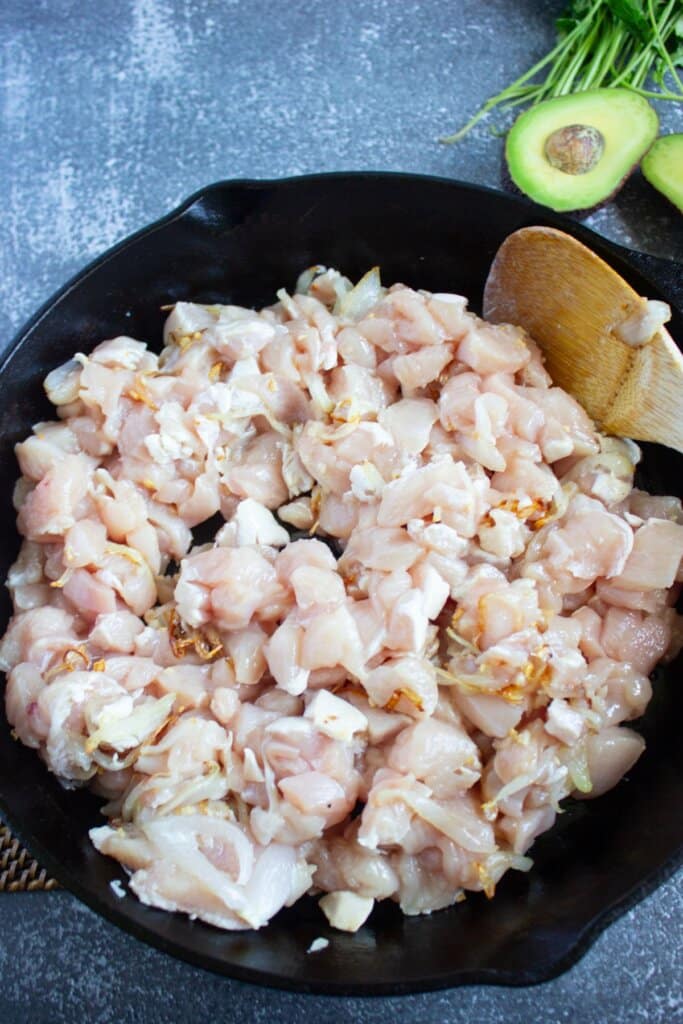 Raw meat in a cast iron skillet.