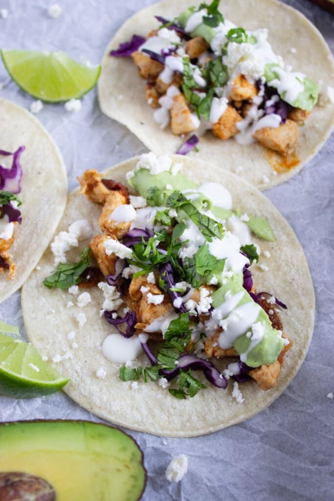 Chipotle chicken tacos on a serving board.