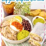 Rice, meat, beans, salsa, guacamole, and sour cream in a white bowl.