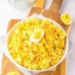 White bowl full of deviled egg pasta salad.