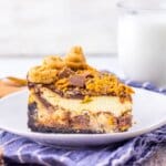 Slice fudge ripple cheesecake on a plate.