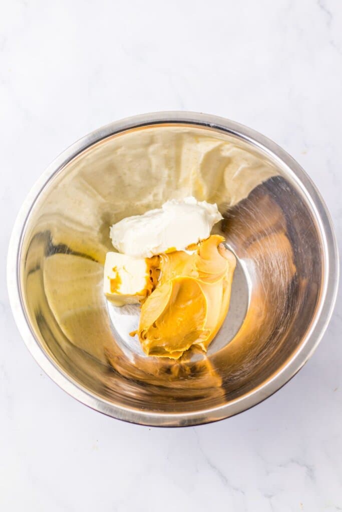 Peanut butter frosting being made in a large mixing bowl.