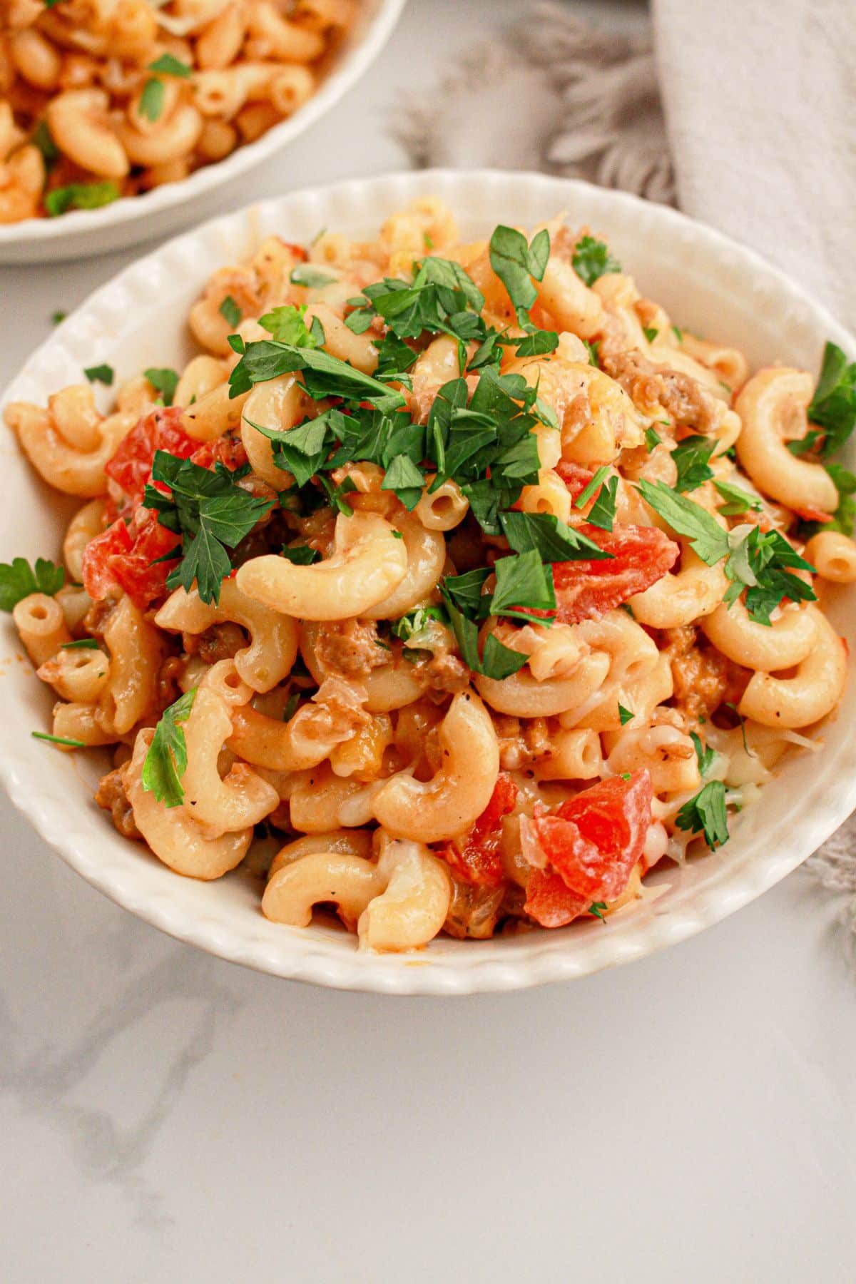 White bowl full of hamburger noodle casserole.