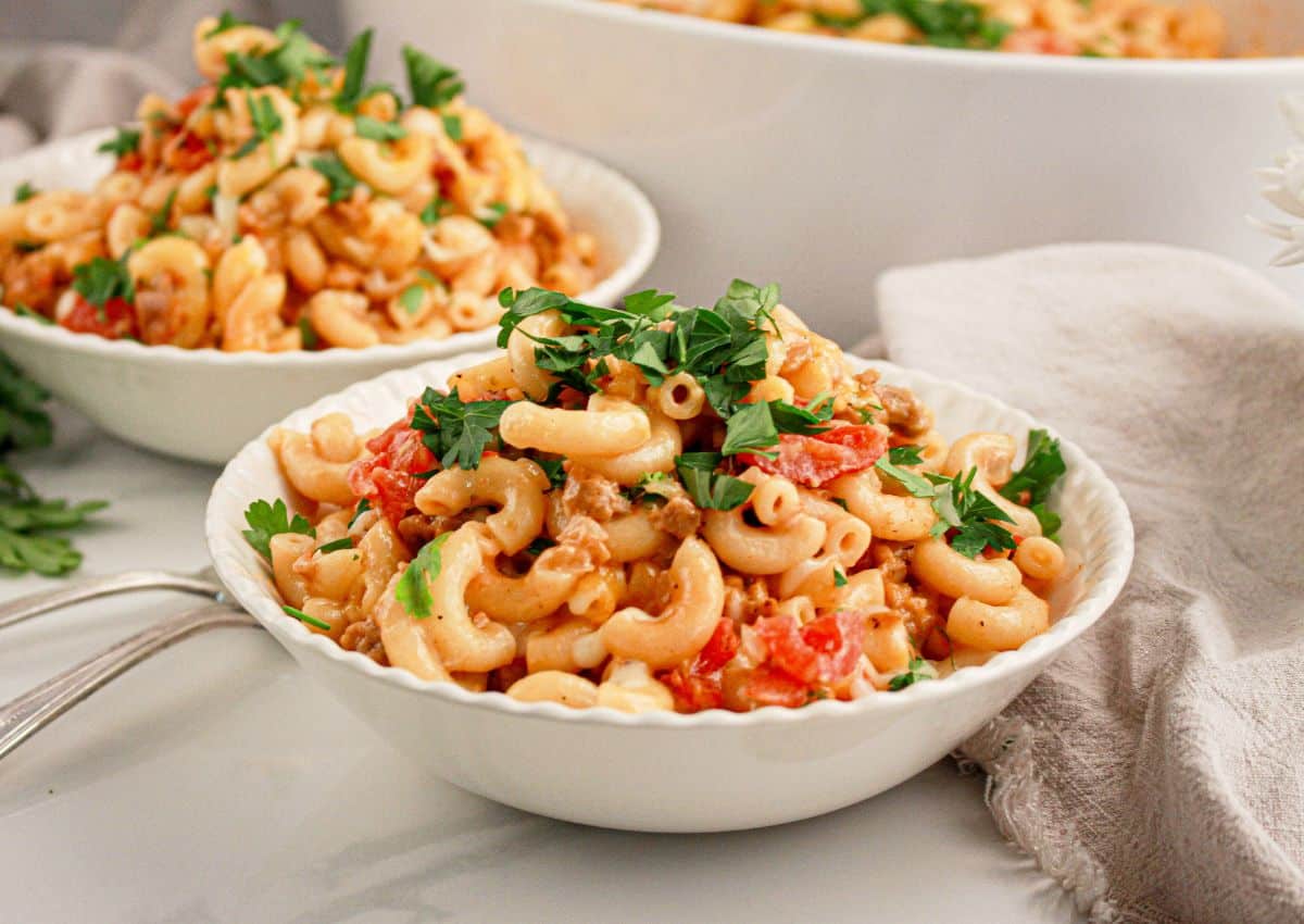 White bowl full of hamburger noodle casserole.