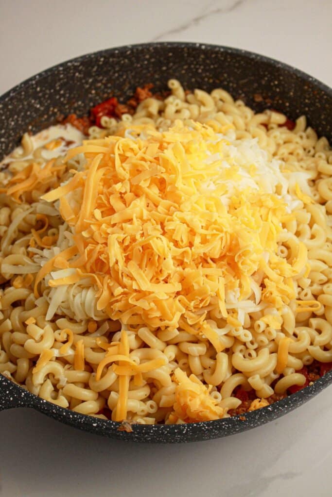 Cheese being mixed into pasta.