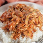 Shredded honey garlic chicken on top of a bed of rice.