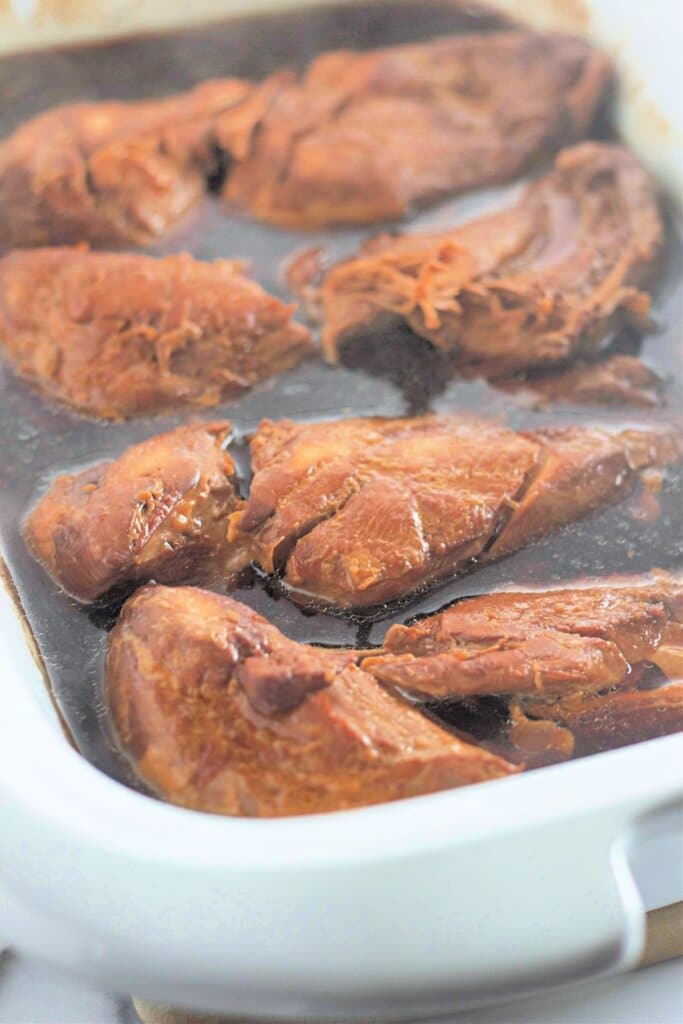 Cooked meat in a crock pot.