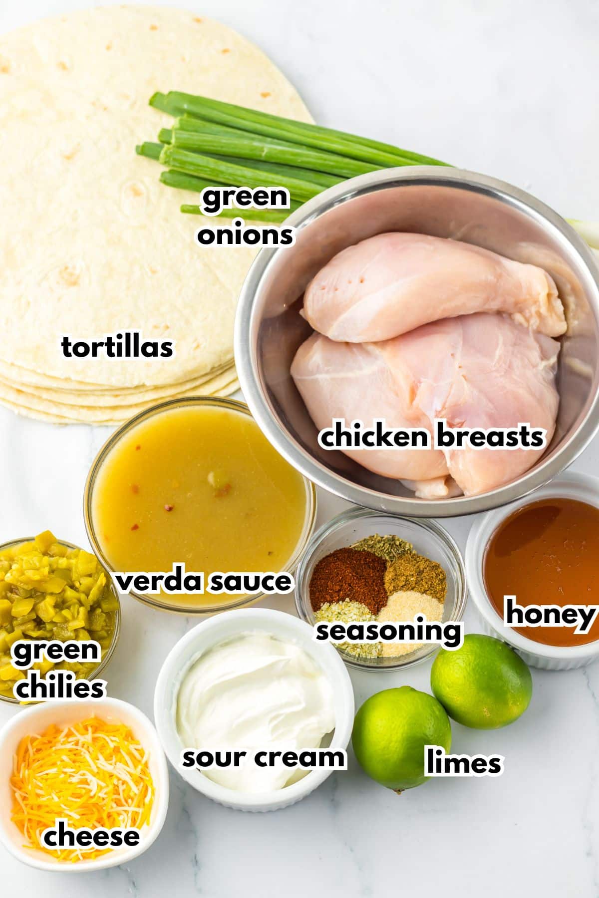 Bowls of ingredients labelled with text on a counter.