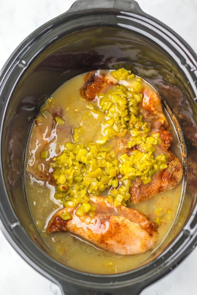 Chicken and sauce in a slow cooker.