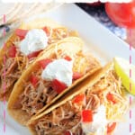 Plate full of mexican shredded chicken tacos.