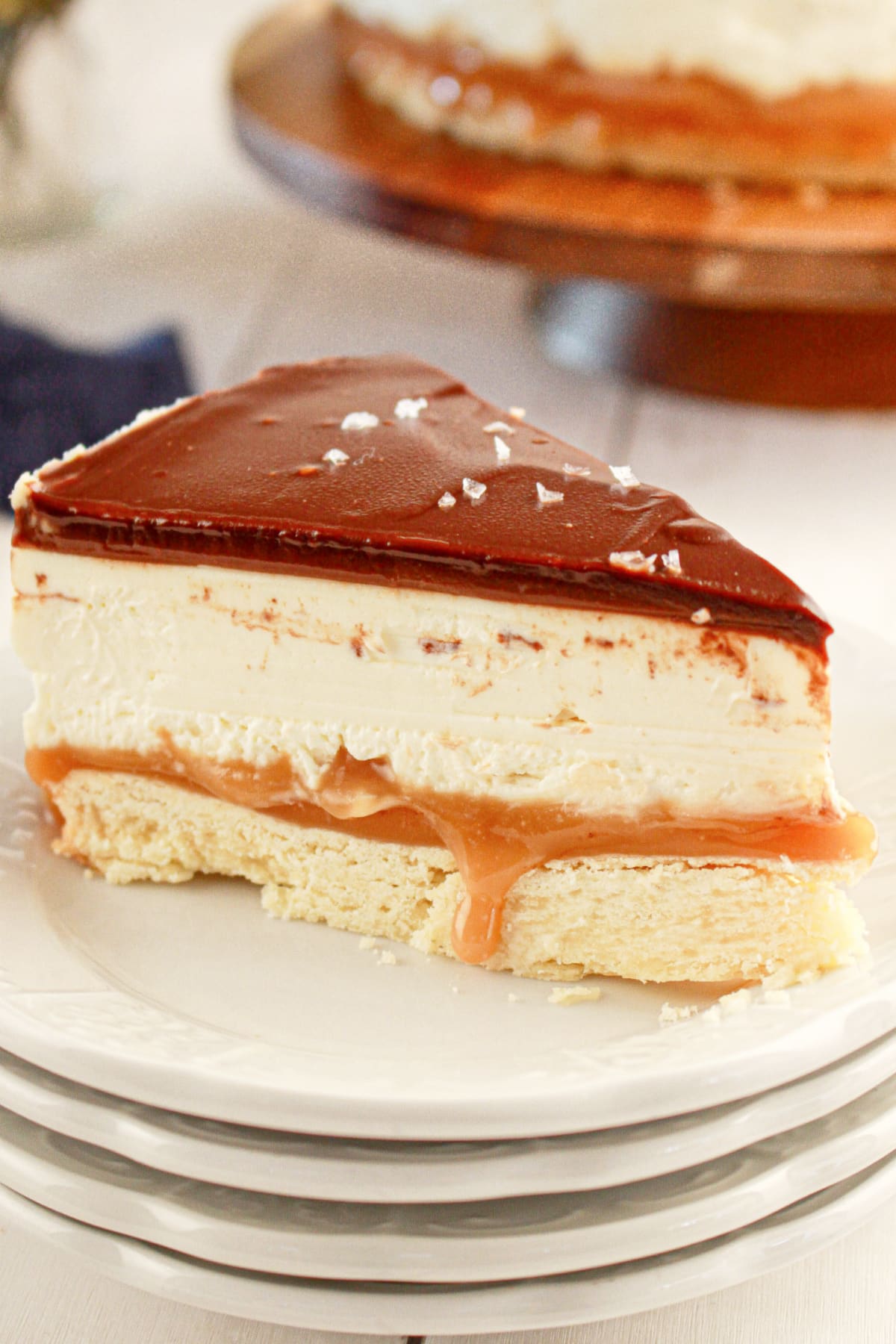 Slice of millionaire cheesecake on a plate.