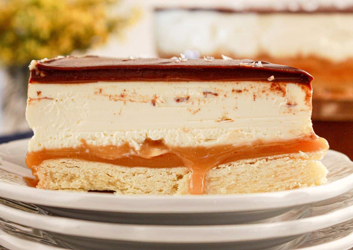 Slice of millionaire cheesecake on a plate.